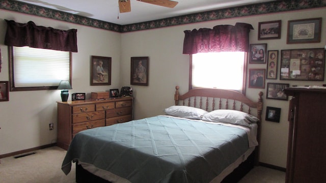 bedroom featuring light carpet and ceiling fan