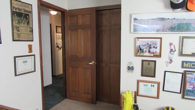 hallway with carpet floors