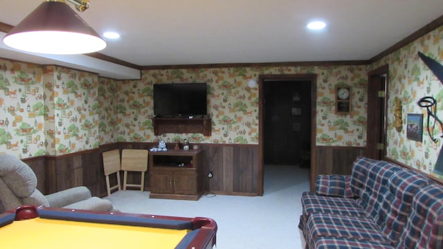 living room featuring carpet floors, crown molding, and wooden walls