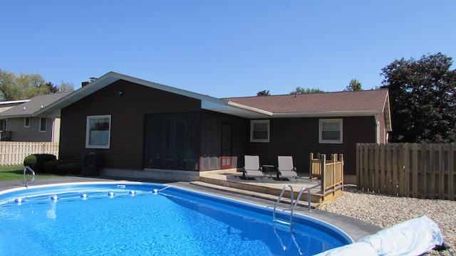 view of pool featuring a sunroom and a patio