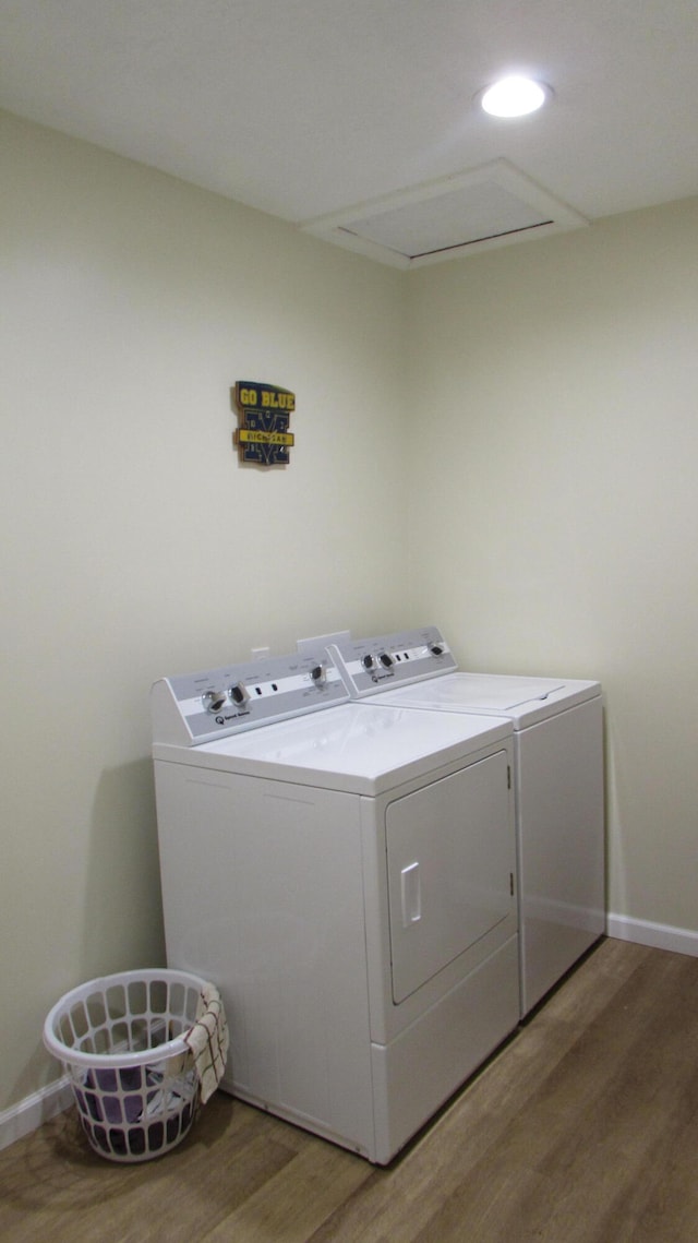 laundry area featuring washer and clothes dryer and wood-type flooring