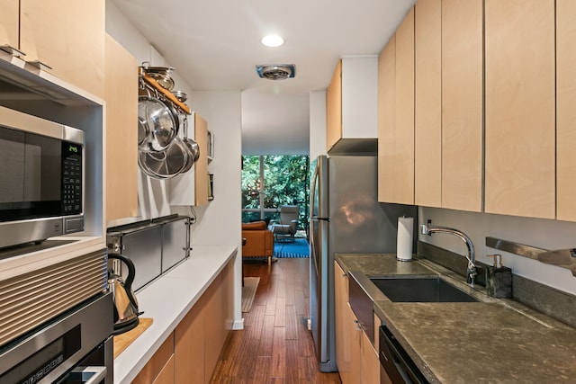 kitchen featuring dark hardwood / wood-style floors, dishwasher, and sink