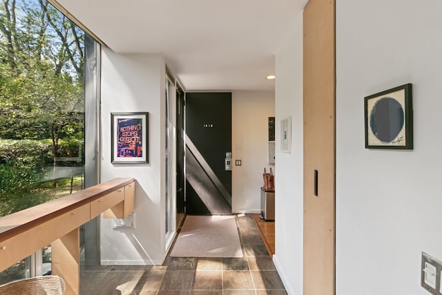 corridor with dark tile patterned floors