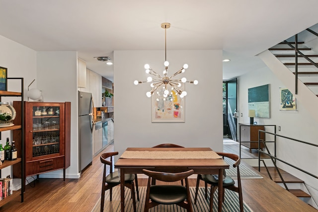 dining area featuring a chandelier and light hardwood / wood-style floors