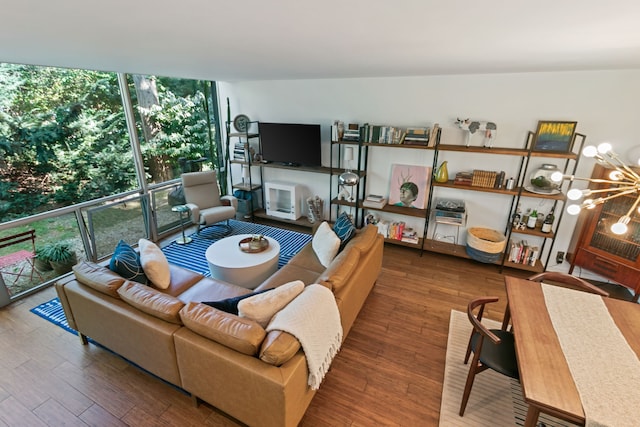 living room with wood-type flooring and a notable chandelier