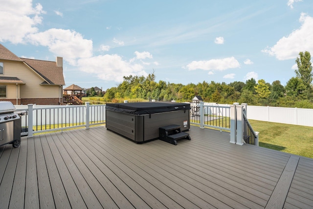 wooden terrace featuring a hot tub