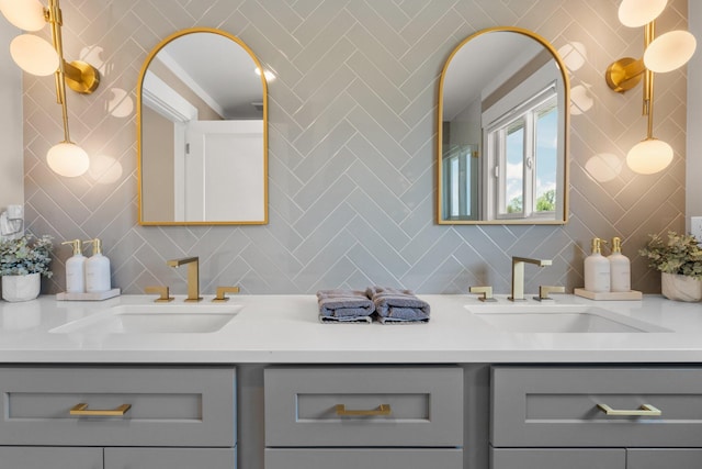 bathroom with vanity and tasteful backsplash