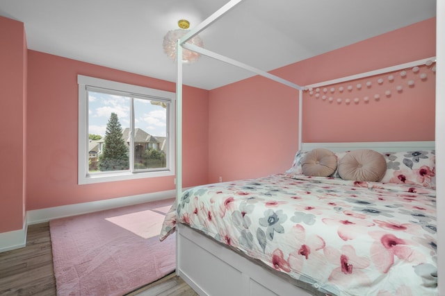 bedroom with hardwood / wood-style floors and ceiling fan