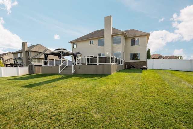 back of house with a gazebo and a lawn