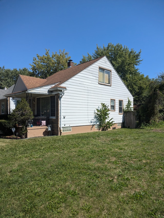 view of side of property with a lawn