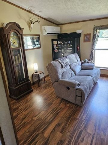 living room featuring a textured ceiling, crown molding, dark wood-type flooring, and a wall unit AC