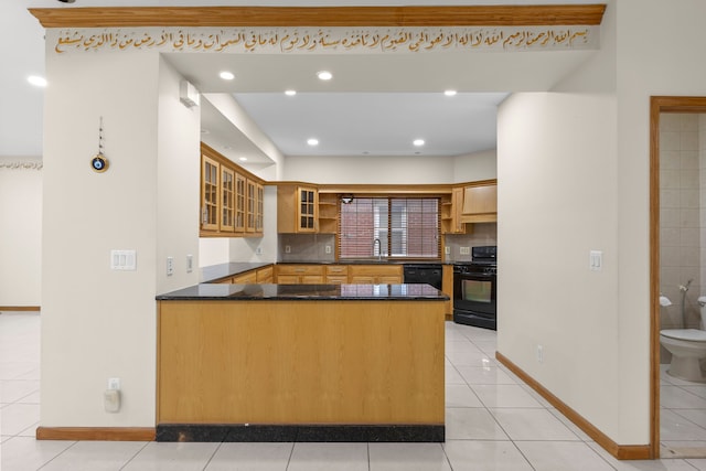 kitchen featuring kitchen peninsula, decorative backsplash, light tile patterned floors, and black appliances