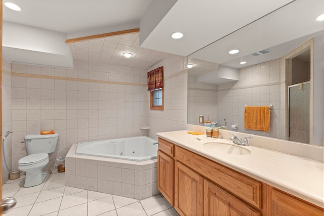 full bathroom with tile patterned flooring, vanity, separate shower and tub, and tile walls