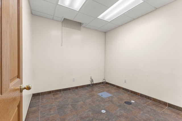 unfurnished room featuring a drop ceiling