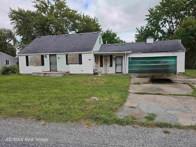 view of front of property with a front yard and a garage