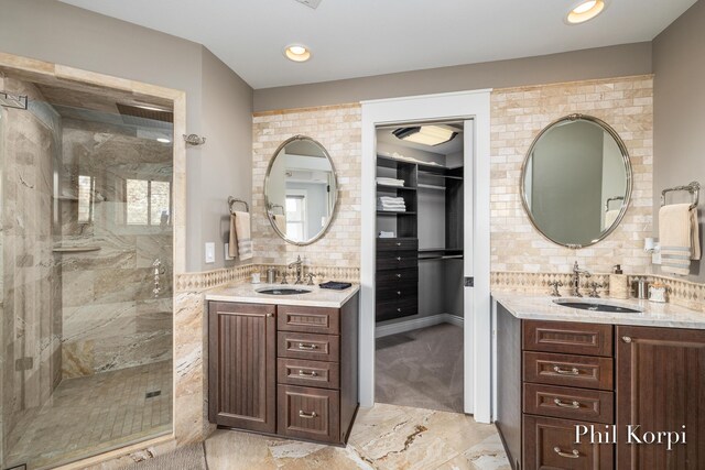 250 Shore Dr, Wayland, MI 49348 - full bath featuring marble finish flooring, a stall shower, two vanities, and recessed lighting