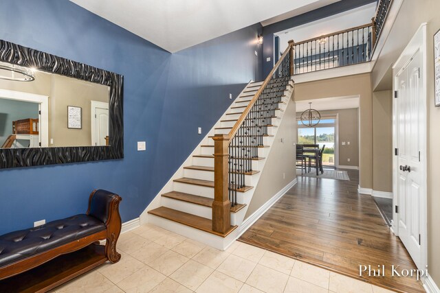 250 Shore Dr, Wayland, MI 49348 - entrance foyer featuring stairs, baseboards, a chandelier, and wood finished floors