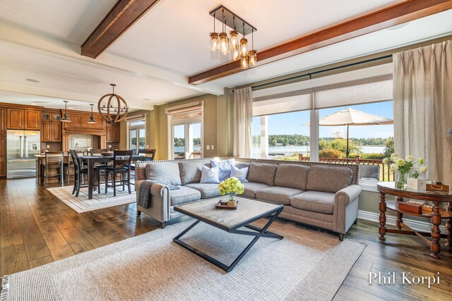 250 Shore Dr, Wayland, MI 49348 - living room featuring a chandelier, beam ceiling, and dark wood-style flooring