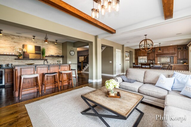 250 Shore Dr, Wayland, MI 49348 - living area featuring a chandelier, stairway, dark wood-type flooring, baseboards, and beverage cooler