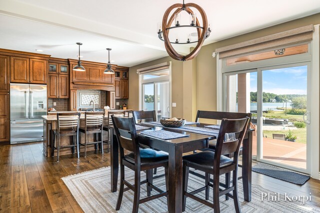 250 Shore Dr, Wayland, MI 49348 - dining area with healthy amount of natural light, a chandelier, and dark wood-type flooring