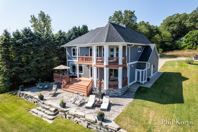 250 Shore Dr, Wayland, MI 49348 - view of front of house with a patio area, a wooden deck, a front yard, a balcony, and roof with shingles