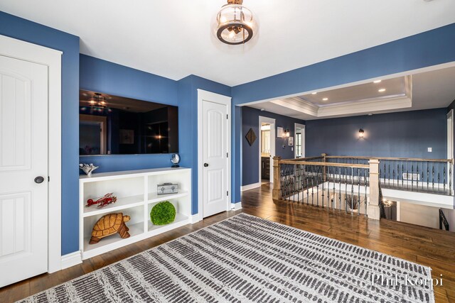 250 Shore Dr, Wayland, MI 49348 - unfurnished room with an upstairs landing, wood finished floors, baseboards, and a raised ceiling