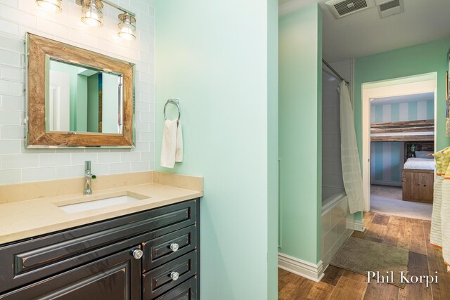 250 Shore Dr, Wayland, MI 49348 - bathroom featuring wood finished floors, vanity, and shower / bath combo with shower curtain
