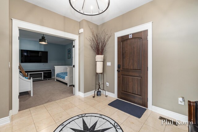 250 Shore Dr, Wayland, MI 49348 - foyer featuring a chandelier, baseboards, and carpet