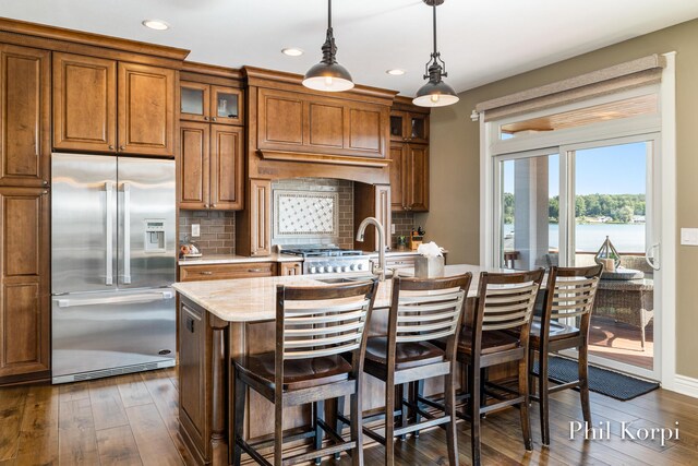 250 Shore Dr, Wayland, MI 49348 - kitchen featuring stainless steel built in refrigerator, brown cabinetry, dark wood-style flooring, decorative backsplash, and recessed lighting