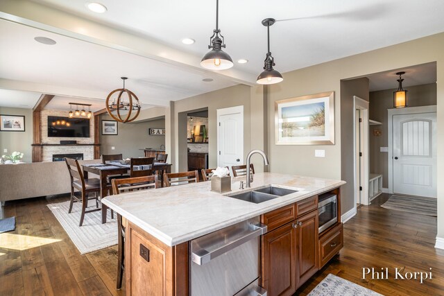 250 Shore Dr, Wayland, MI 49348 - kitchen with a sink, stainless steel appliances, a center island with sink, dark wood-type flooring, and open floor plan