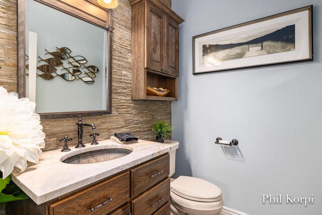 250 Shore Dr, Wayland, MI 49348 - bathroom with decorative backsplash, vanity, and toilet