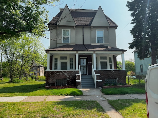 view of front of home with a porch and a front lawn