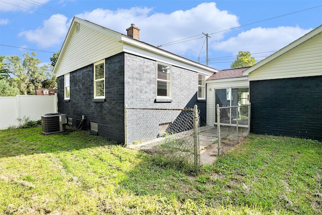 exterior space featuring central AC and a lawn