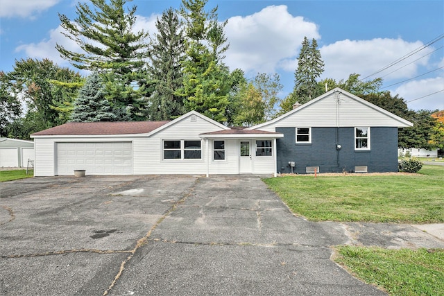 ranch-style house with a garage and a front lawn