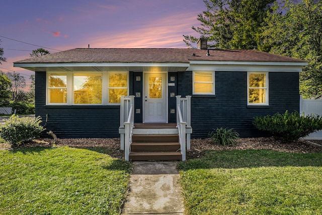 view of front of property with a yard