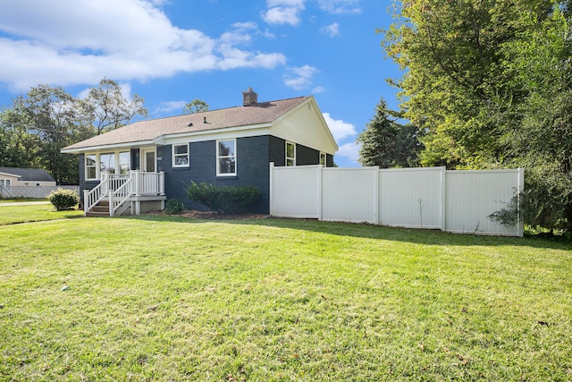 back of property with a lawn