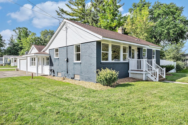 5344 Lapeer Rd, Burton, MI 48509 - view of front of house with an attached garage, brick siding, driveway, a chimney, and a front yard