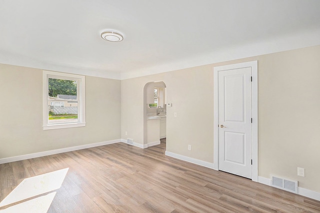 empty room with light hardwood / wood-style flooring