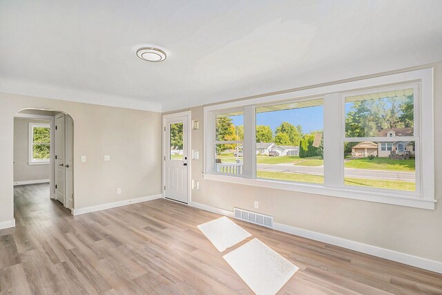 5344 Lapeer Rd, Burton, MI 48509 - entrance foyer with arched walkways, baseboards, and light wood-style floors