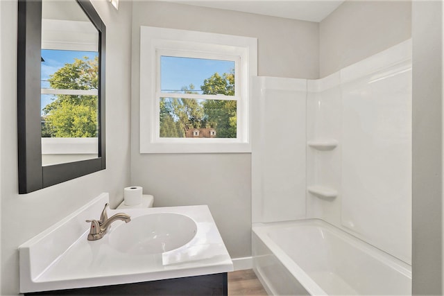 bathroom with shower / tub combination, vanity, and wood-type flooring