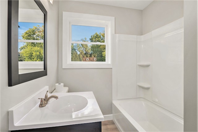 5344 Lapeer Rd, Burton, MI 48509 - full bath with plenty of natural light, vanity, bathtub / shower combination, and baseboards