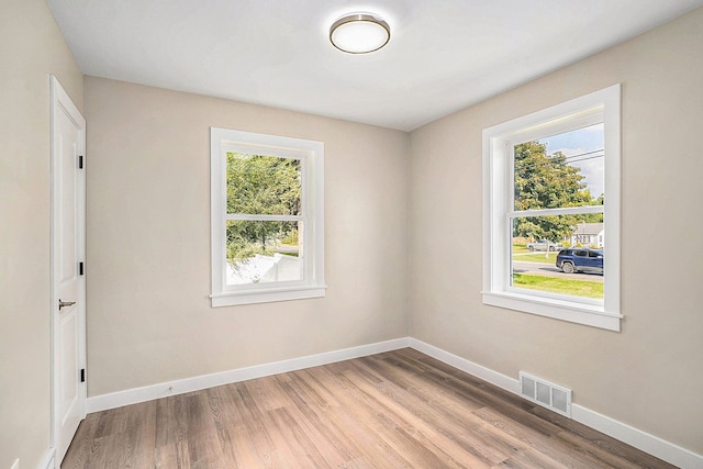 spare room with light hardwood / wood-style flooring