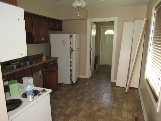 kitchen with plenty of natural light, dark brown cabinetry, and sink