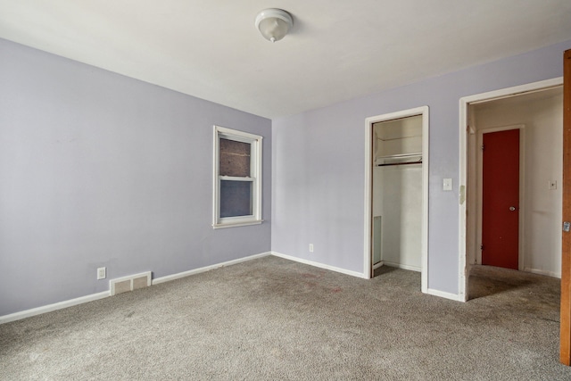 unfurnished bedroom with a closet and carpet floors