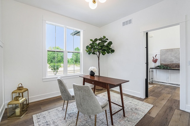 office with hardwood / wood-style flooring, baseboards, and visible vents