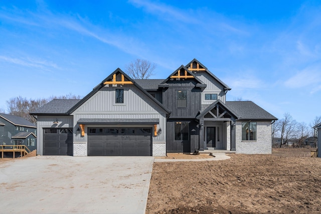 modern farmhouse featuring a garage, driveway, board and batten siding, and roof with shingles