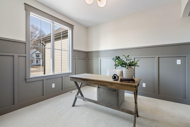 carpeted office with a wainscoted wall and a decorative wall