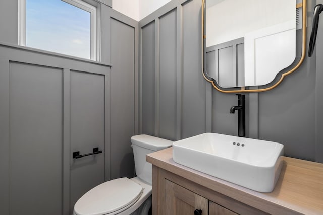 bathroom featuring toilet and vanity