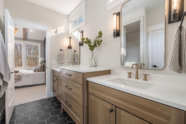 full bath with a sink, two vanities, ensuite bath, and tile patterned floors