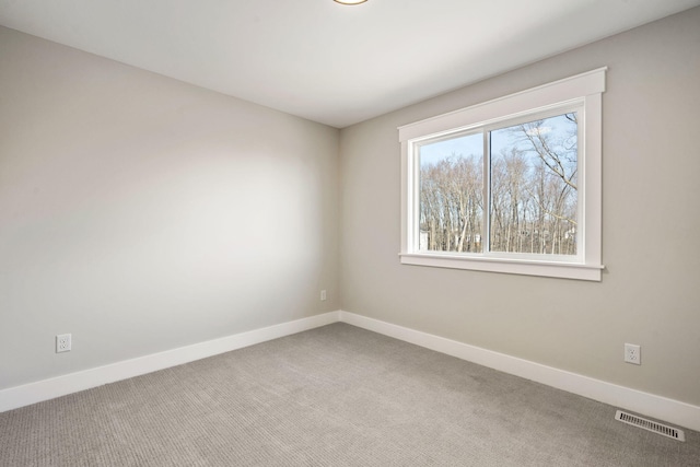 unfurnished room featuring visible vents, baseboards, and carpet floors